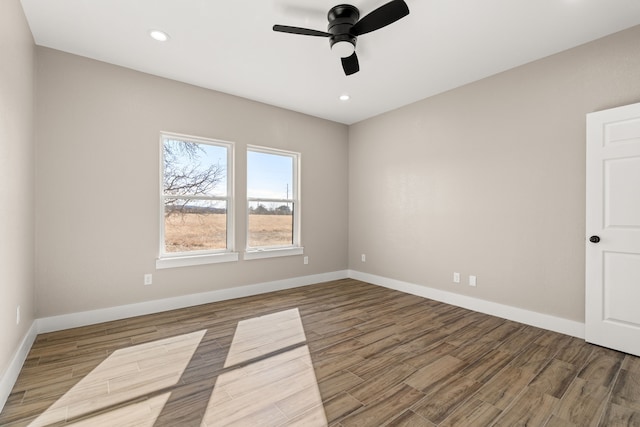 empty room with hardwood / wood-style flooring and ceiling fan