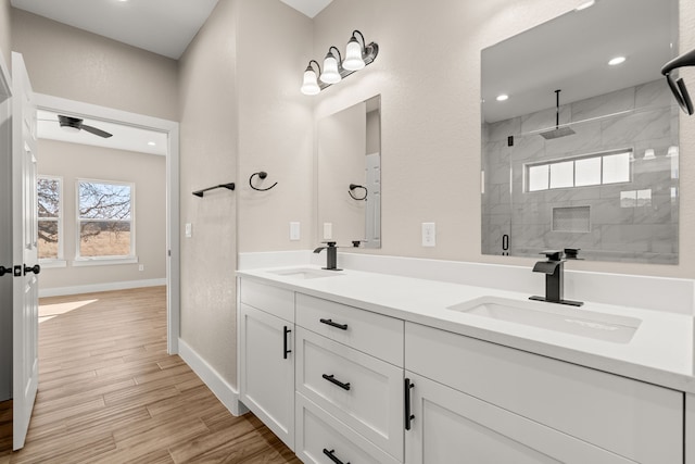 bathroom with vanity, ceiling fan, and a shower with shower door