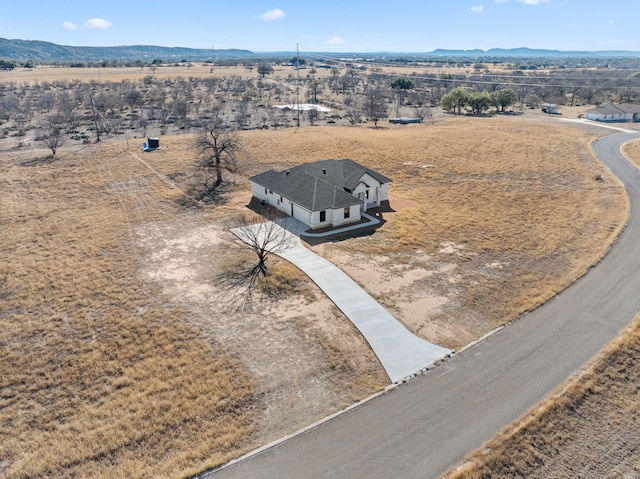 drone / aerial view with a mountain view and a rural view