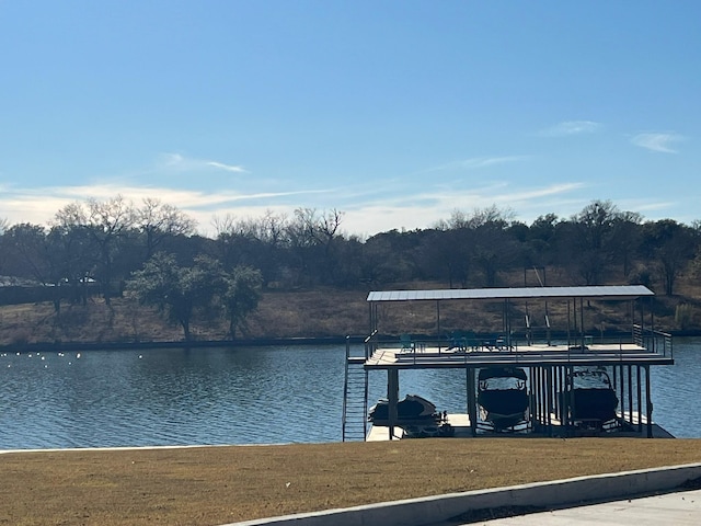 view of dock featuring a yard and a water view