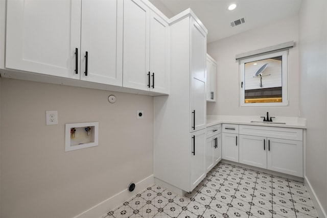 washroom featuring cabinets, electric dryer hookup, sink, and washer hookup