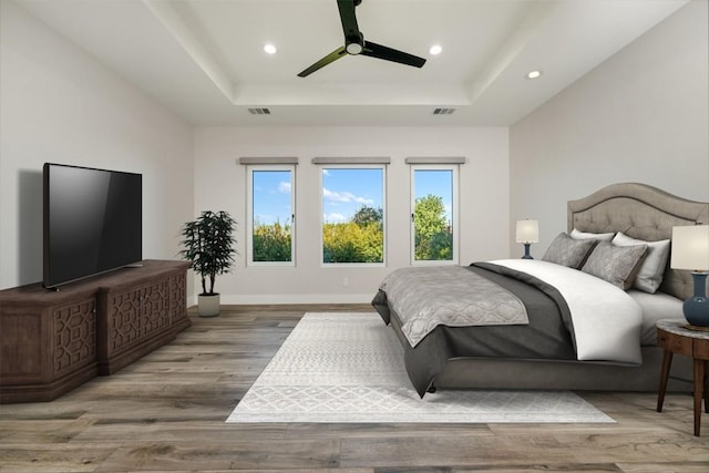 104 Cactus Cor, Horseshoe Bay, TX 78657 - bedroom featuring a tray ceiling, wood finished floors, recessed lighting, ceiling fan, and baseboards