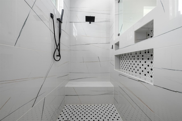 bathroom with a tile shower