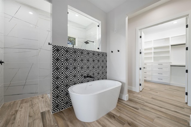 bathroom with plus walk in shower and hardwood / wood-style floors