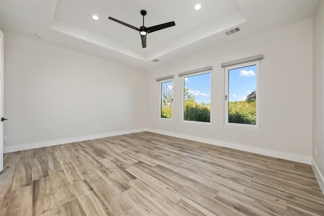 104 Cactus Cor, Horseshoe Bay, TX 78657 - empty room featuring a tray ceiling, a ceiling fan, light wood-style flooring, recessed lighting, and baseboards