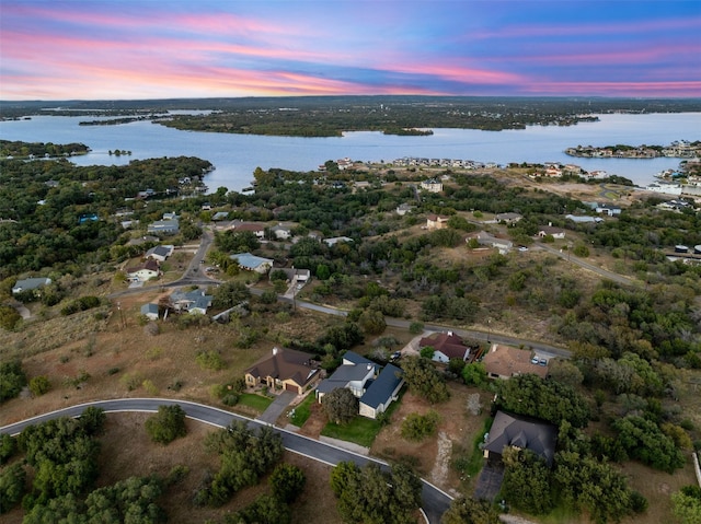 aerial view at dusk with a water view