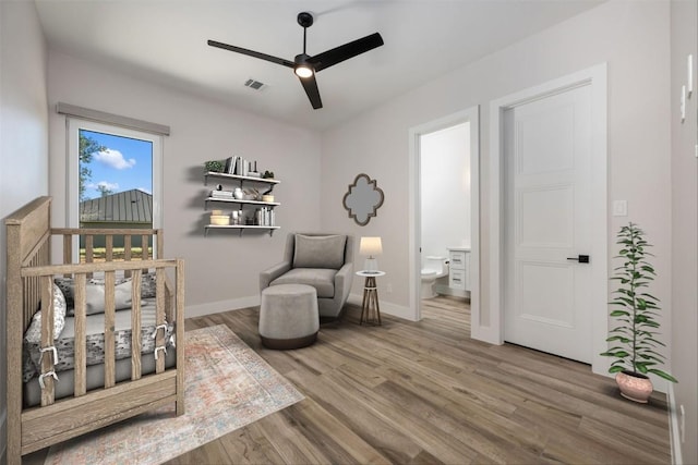 104 Cactus Cor, Horseshoe Bay, TX 78657 - bedroom featuring wood finished floors, baseboards, connected bathroom, and a ceiling fan