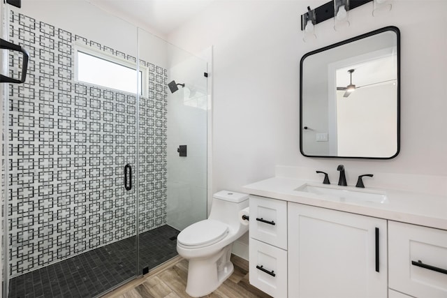 bathroom featuring vanity, hardwood / wood-style floors, toilet, and an enclosed shower