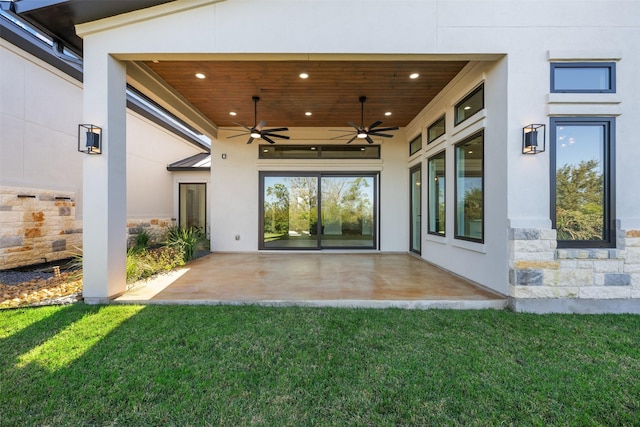 exterior space featuring a patio, ceiling fan, and a lawn