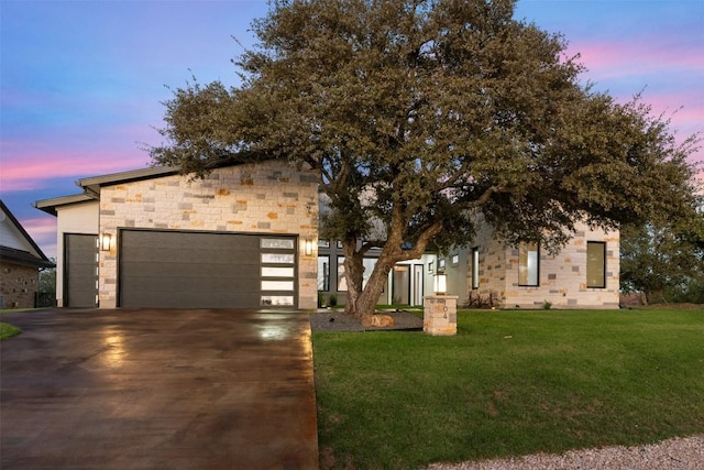 104 Cactus Cor, Horseshoe Bay, TX 78657 - contemporary house featuring concrete driveway, a garage, a lawn, and stone siding