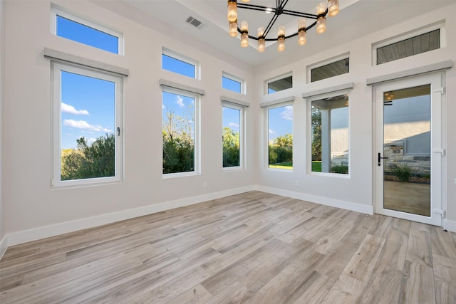 unfurnished sunroom with an inviting chandelier and plenty of natural light