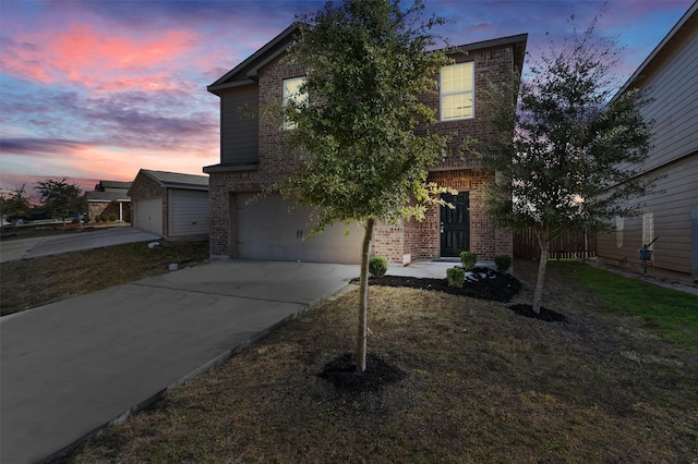 view of front of home with a yard and a garage