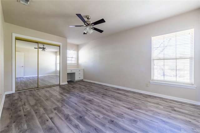 unfurnished bedroom with ceiling fan, a closet, and light hardwood / wood-style flooring