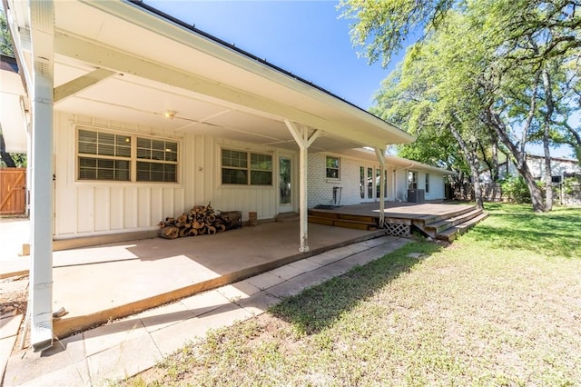 exterior space with a yard, a deck, and a patio area