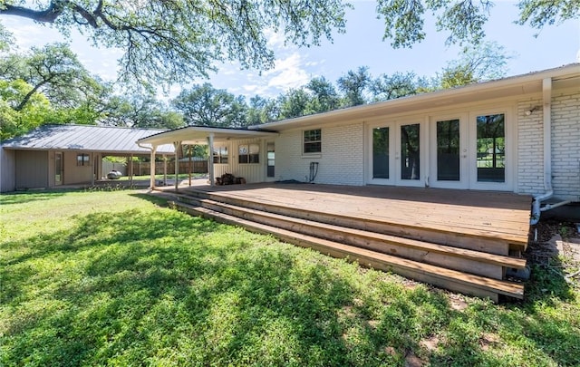 rear view of property featuring french doors, a deck, and a lawn