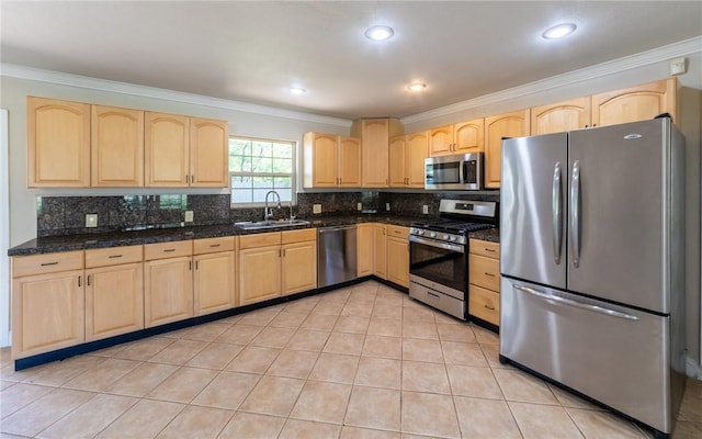 kitchen with light tile patterned flooring, sink, ornamental molding, appliances with stainless steel finishes, and backsplash