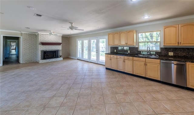 kitchen featuring a healthy amount of sunlight, sink, backsplash, and dishwasher