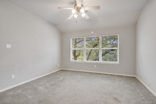 empty room with carpet floors, lofted ceiling, baseboards, and a ceiling fan