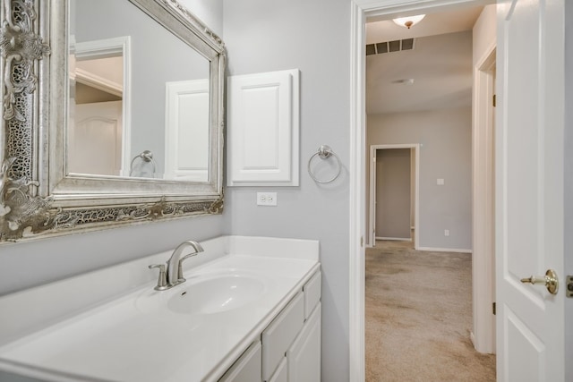 bathroom featuring visible vents, vanity, and baseboards