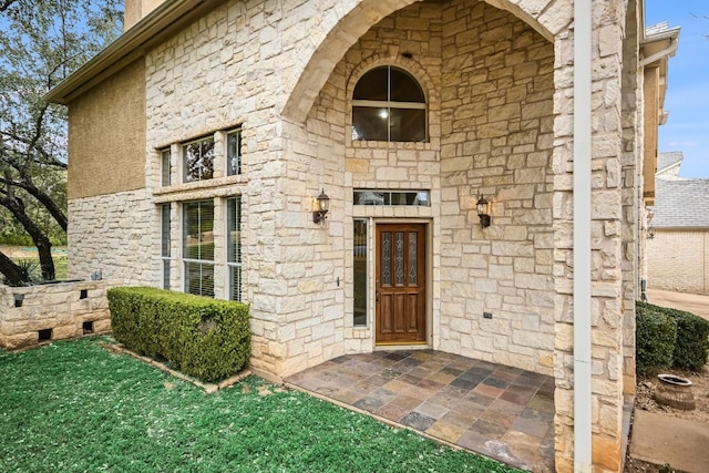 doorway to property featuring stone siding