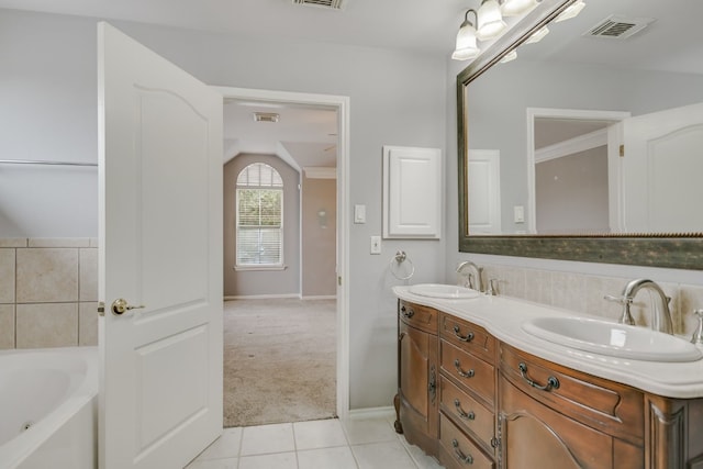 bathroom featuring visible vents, a sink, and double vanity