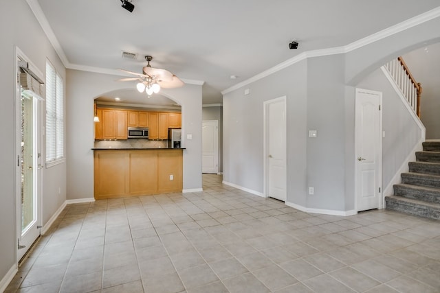 kitchen featuring stainless steel appliances, dark countertops, visible vents, and crown molding