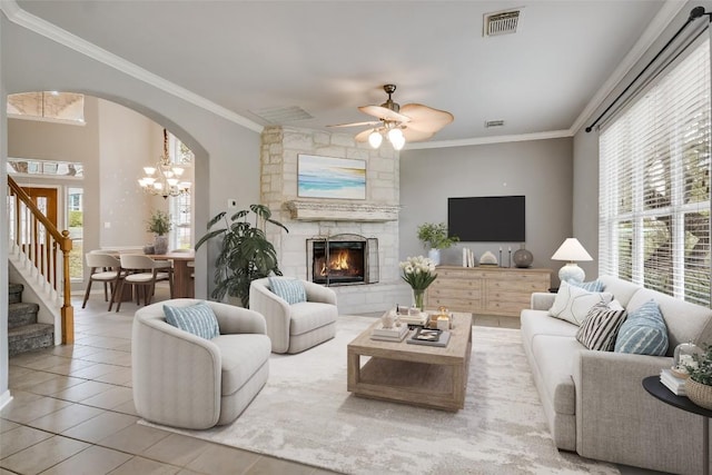 living room featuring ornamental molding, a healthy amount of sunlight, and tile patterned floors