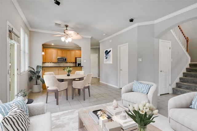 living area featuring light tile patterned floors, stairs, visible vents, and crown molding