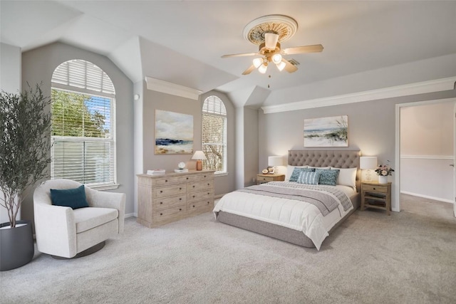 bedroom with lofted ceiling, ceiling fan, baseboards, and light colored carpet