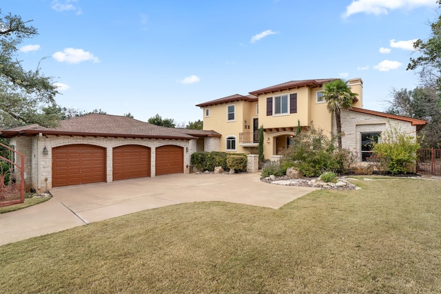 mediterranean / spanish home featuring a garage and a front lawn