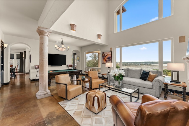 living room with pool table, a healthy amount of sunlight, a high ceiling, and ornate columns