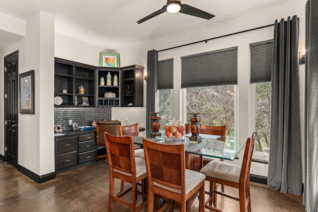 dining room featuring built in desk and ceiling fan