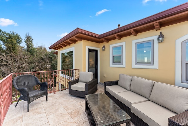 view of patio with a balcony and an outdoor hangout area