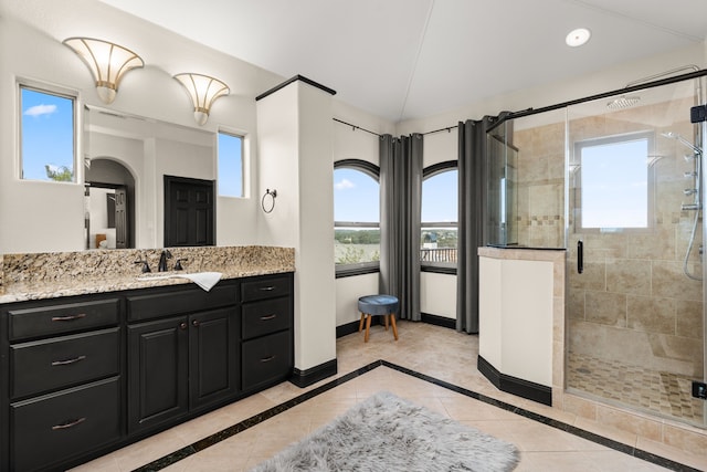 bathroom with vanity and a shower with shower door