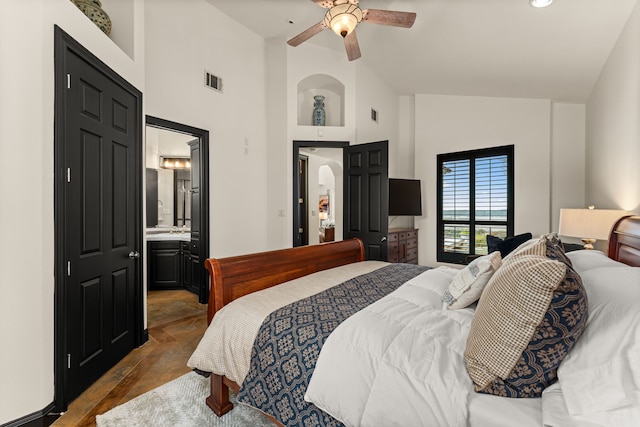 bedroom with lofted ceiling, ensuite bath, and ceiling fan