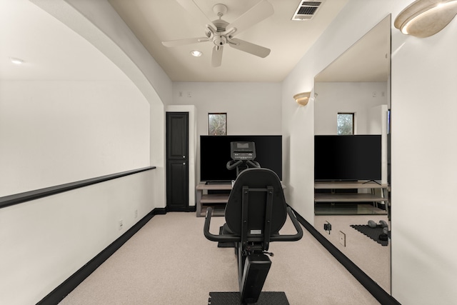 workout area featuring light colored carpet and ceiling fan