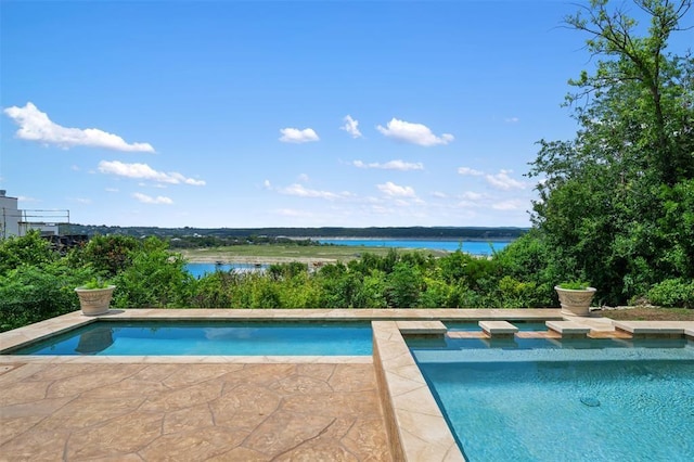 view of pool with a water view