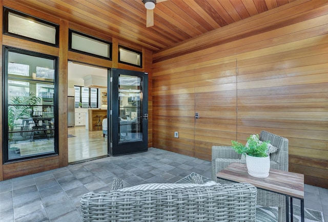 interior space with ceiling fan and a patio area