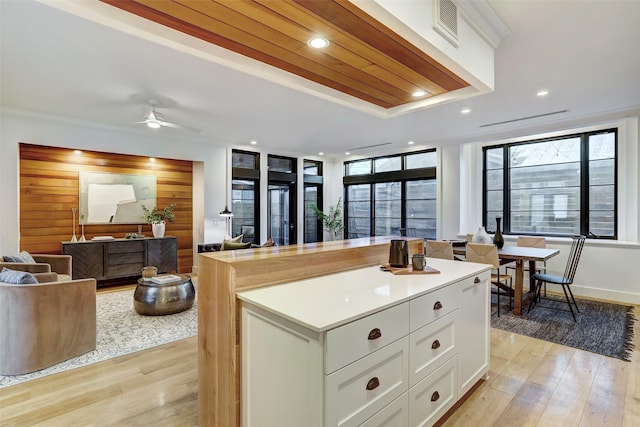 kitchen featuring a kitchen island, white cabinetry, ceiling fan, light hardwood / wood-style floors, and wood ceiling