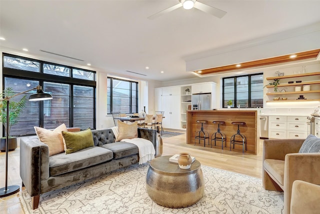 living room featuring light hardwood / wood-style flooring and ceiling fan