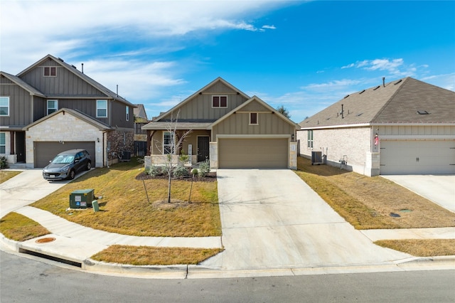 view of front of home with cooling unit, a garage, and a front lawn