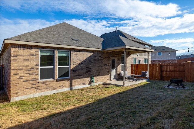 back of property featuring a lawn and a patio