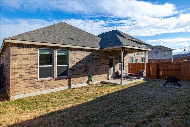 118 Grace Lilly Dr, Buda, TX 78610 - back of house featuring brick siding, a patio area, and roof with shingles