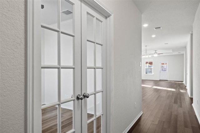 118 Grace Lilly Dr, Buda, TX 78610 - corridor featuring dark wood-style floors, a textured wall, french doors, and recessed lighting