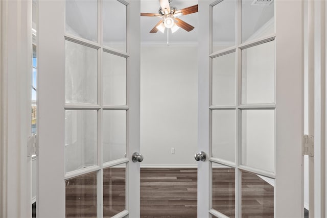 walk in closet with hardwood / wood-style flooring, ceiling fan, and french doors