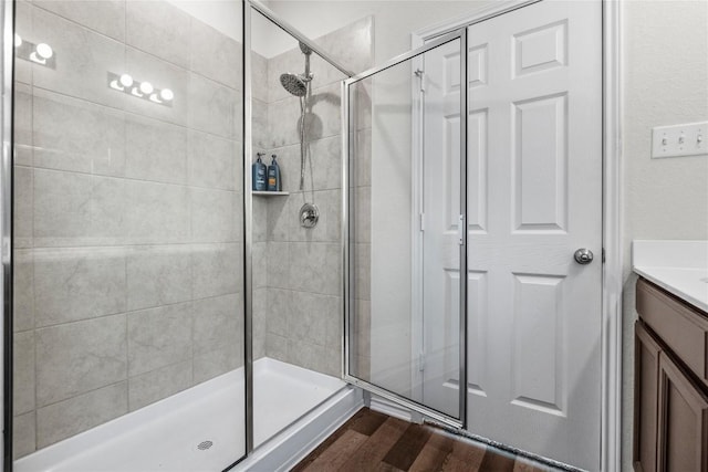 118 Grace Lilly Dr, Buda, TX 78610 - full bath featuring a shower stall, vanity, and wood finished floors