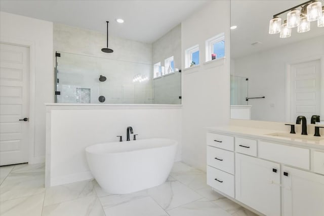 1114 Woodpark Ln, Georgetown, TX 78633 - bathroom with a walk in shower, a freestanding bath, vanity, marble finish floors, and recessed lighting