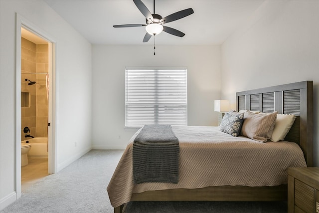 carpeted bedroom with ceiling fan and ensuite bathroom