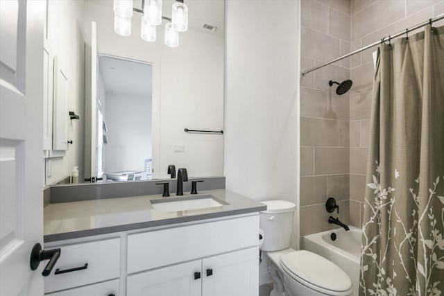 full bathroom with shower / tub combo with curtain, vanity, and toilet