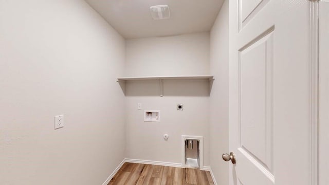 laundry area with hookup for a washing machine, electric dryer hookup, light hardwood / wood-style floors, and hookup for a gas dryer